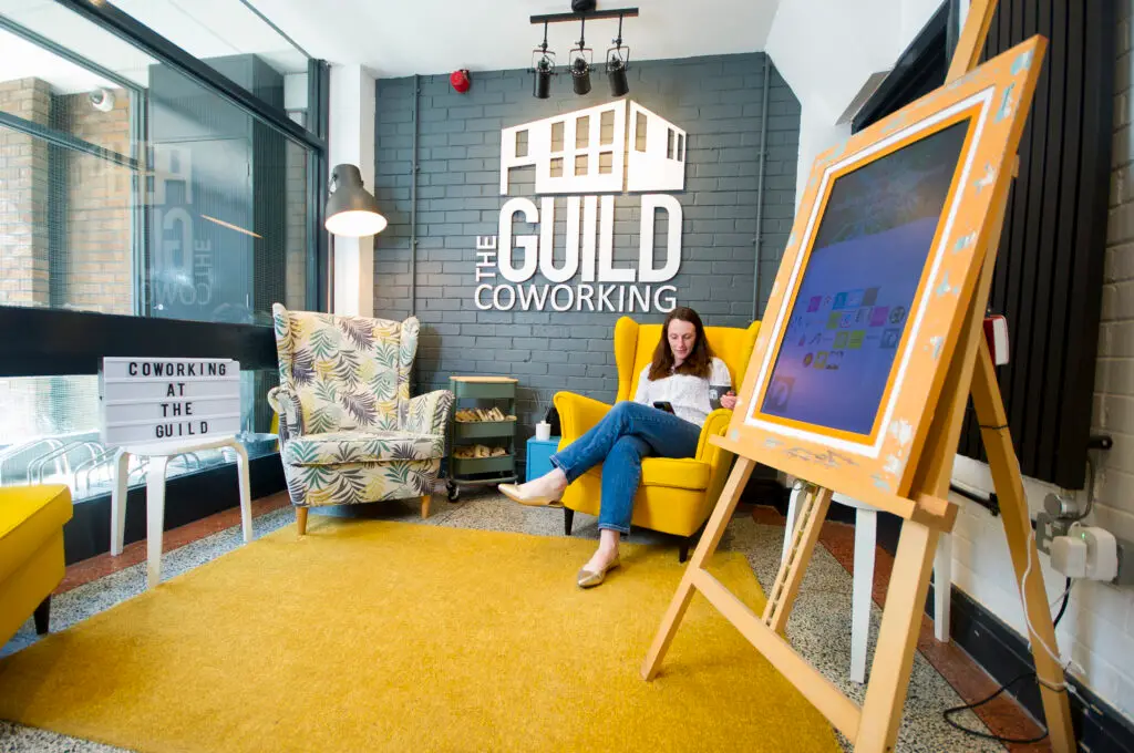 Member sitting at one of our downstairs coworking seating areas.